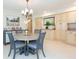 Bright dining area with round table and four chairs, adjacent to kitchen at 907 La Jolla Ave, Sun City Center, FL 33573