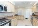 Kitchen boasting stainless steel appliances and light-toned cabinetry at 907 La Jolla Ave, Sun City Center, FL 33573