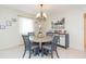 Dining area featuring a round table, four chairs, and elegant chandelier at 907 La Jolla Ave, Sun City Center, FL 33573