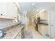View of a kitchen with light-colored cabinets, stainless steel appliances, and granite countertops at 907 La Jolla Ave, Sun City Center, FL 33573