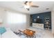 Living room with white couch, wooden coffee table, and blue accent wall at 907 La Jolla Ave, Sun City Center, FL 33573