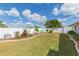 Landscaped backyard with grassy lawn and blue rock feature at 907 La Jolla Ave, Sun City Center, FL 33573