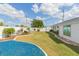 Landscaped backyard with grassy lawn and blue rock feature at 907 La Jolla Ave, Sun City Center, FL 33573