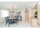 Spacious dining area with a round table and chairs, and an adjacent kitchen at 907 La Jolla Ave, Sun City Center, FL 33573