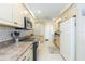 Open concept kitchen with stainless steel appliances and light colored cabinetry at 907 La Jolla Ave, Sun City Center, FL 33573