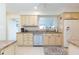 Bright kitchen with ample cabinetry, stainless steel appliances, and granite countertops at 907 La Jolla Ave, Sun City Center, FL 33573