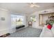 Relaxing sunroom with backyard view, plush seating, and large windows at 907 La Jolla Ave, Sun City Center, FL 33573