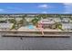 Aerial view showing community pool, dock, and surrounding buildings at 4789 Coquina Key Se Dr, St Petersburg, FL 33705