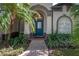 Inviting front entry with a teal door and landscaped walkway at 4303 Balington Dr, Valrico, FL 33596