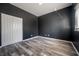 Spacious bedroom with dark gray walls and wood-look floors at 4303 Balington Dr, Valrico, FL 33596