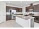 Open concept kitchen with dark cabinetry, stainless steel appliances, and an island with granite countertops at 15876 Mulrion Blvd, Punta Gorda, FL 33982