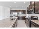 This kitchen features granite counters, stainless appliances, dark cabinets, and recessed lighting at 15876 Mulrion Blvd, Punta Gorda, FL 33982