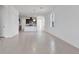 Open concept home showing dining and kitchen area with white tile flooring and walls at 15876 Mulrion Blvd, Punta Gorda, FL 33982