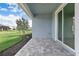 Covered outdoor patio with stone pavers and sliding glass doors, perfect for entertaining at 15876 Mulrion Blvd, Punta Gorda, FL 33982