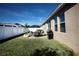 Relaxing backyard with patio furniture and grassy area at 2117 Valterra Vista Way, Valrico, FL 33594