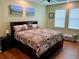 Spacious bedroom with king-size bed and wood floors at 2117 Valterra Vista Way, Valrico, FL 33594