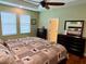 Spacious bedroom with two windows, dresser, and king-size bed at 2117 Valterra Vista Way, Valrico, FL 33594