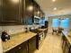 Kitchen boasts dark cabinetry and granite countertops at 2117 Valterra Vista Way, Valrico, FL 33594