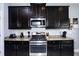 Kitchen features granite countertops and dark wood cabinets at 2117 Valterra Vista Way, Valrico, FL 33594