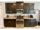 Kitchen with stainless steel appliances and dark cabinets at 2117 Valterra Vista Way, Valrico, FL 33594