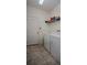 Laundry room with washer, dryer, and extra shelving at 2117 Valterra Vista Way, Valrico, FL 33594
