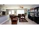 Spacious living room with brown sofas and a coffee table at 2117 Valterra Vista Way, Valrico, FL 33594