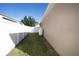 Side yard with grassy area, privacy fence, and gas tank at 2117 Valterra Vista Way, Valrico, FL 33594