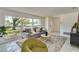 Bright living room featuring a gray sofa, large windows, and stylish decor at 3275 Fox Hill Dr, Clearwater, FL 33761