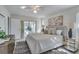 Main bedroom with striped bedding and access to the pool at 3275 Fox Hill Dr, Clearwater, FL 33761