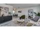 Open living area with gray sofa, modern decor, and views into the dining area at 3275 Fox Hill Dr, Clearwater, FL 33761