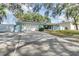 Light blue single story home with a driveway at 3275 Fox Hill Dr, Clearwater, FL 33761