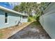 Side yard with a white vinyl fence and some landscaping at 3275 Fox Hill Dr, Clearwater, FL 33761