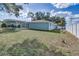 Backyard view of house, pool, and privacy fence at 3275 Fox Hill Dr, Clearwater, FL 33761