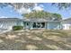 Light blue single story home with a two car garage at 3275 Fox Hill Dr, Clearwater, FL 33761
