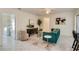 Cozy den with teal sofa and adjacent laundry room access at 3275 Fox Hill Dr, Clearwater, FL 33761