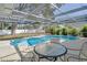 Relaxing pool area with patio furniture under a screened enclosure at 3275 Fox Hill Dr, Clearwater, FL 33761