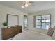 Bedroom with striped bedding, dresser, and direct pool access at 3275 Fox Hill Dr, Clearwater, FL 33761