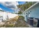 Large backyard with a white vinyl fence and mature trees at 3275 Fox Hill Dr, Clearwater, FL 33761
