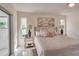 Main bedroom with king-size bed, striped bedding and access to the patio at 3275 Fox Hill Dr, Clearwater, FL 33761