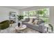 Spacious living room with gray sofa and large windows overlooking the backyard at 3275 Fox Hill Dr, Clearwater, FL 33761