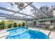 Refreshing kidney-shaped pool with screened patio cover at 3275 Fox Hill Dr, Clearwater, FL 33761