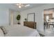 Spacious main bedroom with striped bedding and adjacent bathroom and kitchen at 3275 Fox Hill Dr, Clearwater, FL 33761