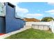 View of the backyard featuring a pool and well-maintained lawn on a sunny day at 4004 Claremont Dr, New Port Richey, FL 34652