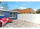Cozy backyard with a brick-paved patio and a comfortable red sofa set at 4004 Claremont Dr, New Port Richey, FL 34652