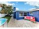 Spacious backyard with an above-ground pool, lush lawn, and brick patio with seating at 4004 Claremont Dr, New Port Richey, FL 34652