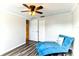 Bedroom showcasing a comfortable chaise lounge, closet space, and ceiling fan at 4004 Claremont Dr, New Port Richey, FL 34652