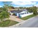 Charming single-Gathering home with blue accents, a well-kept lawn, and mature trees at 4004 Claremont Dr, New Port Richey, FL 34652