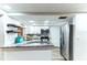 Updated kitchen with granite countertops, white cabinets, and stainless steel appliances at 4004 Claremont Dr, New Port Richey, FL 34652