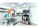 Updated kitchen with granite countertops, white cabinets, and stainless steel appliances at 4004 Claremont Dr, New Port Richey, FL 34652