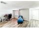 Bright room with wood floors, a window, and a cozy sitting area with a desk at 4004 Claremont Dr, New Port Richey, FL 34652